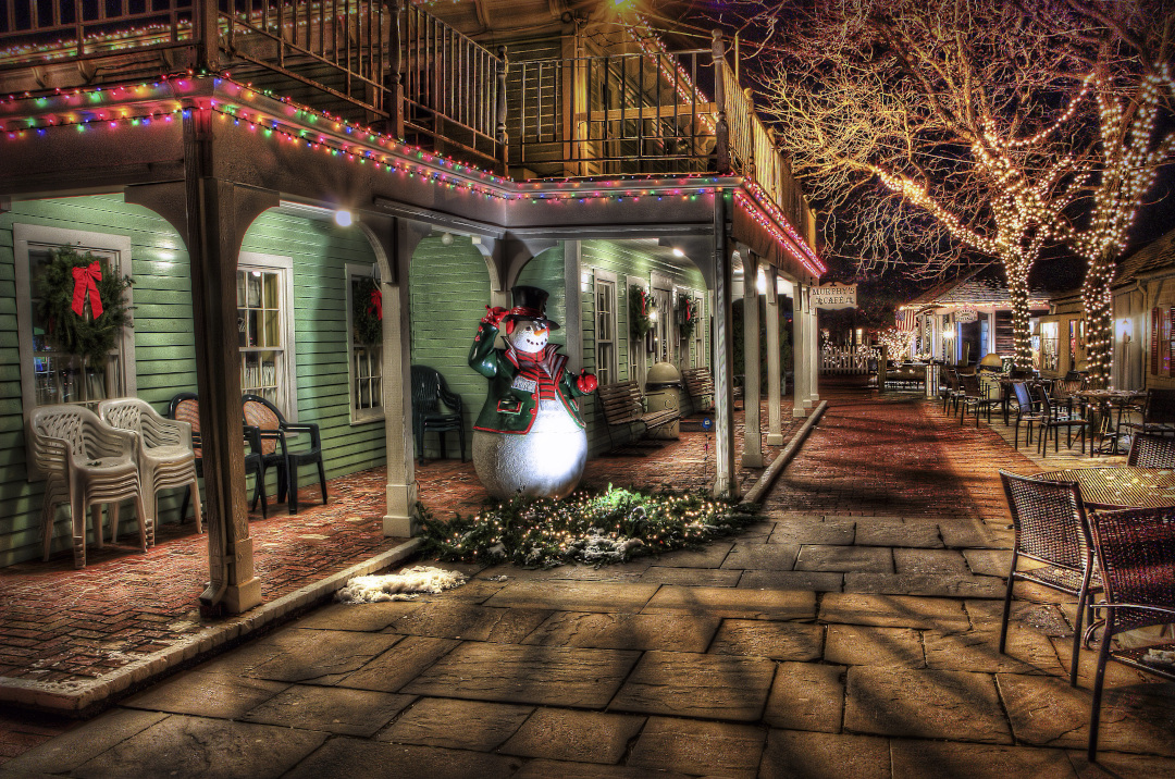 a snowman in front of a cafe