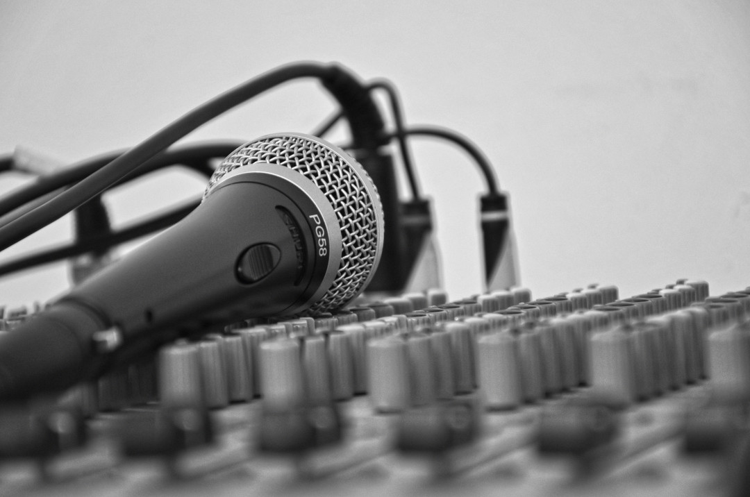 a microphone on an audio mixing console